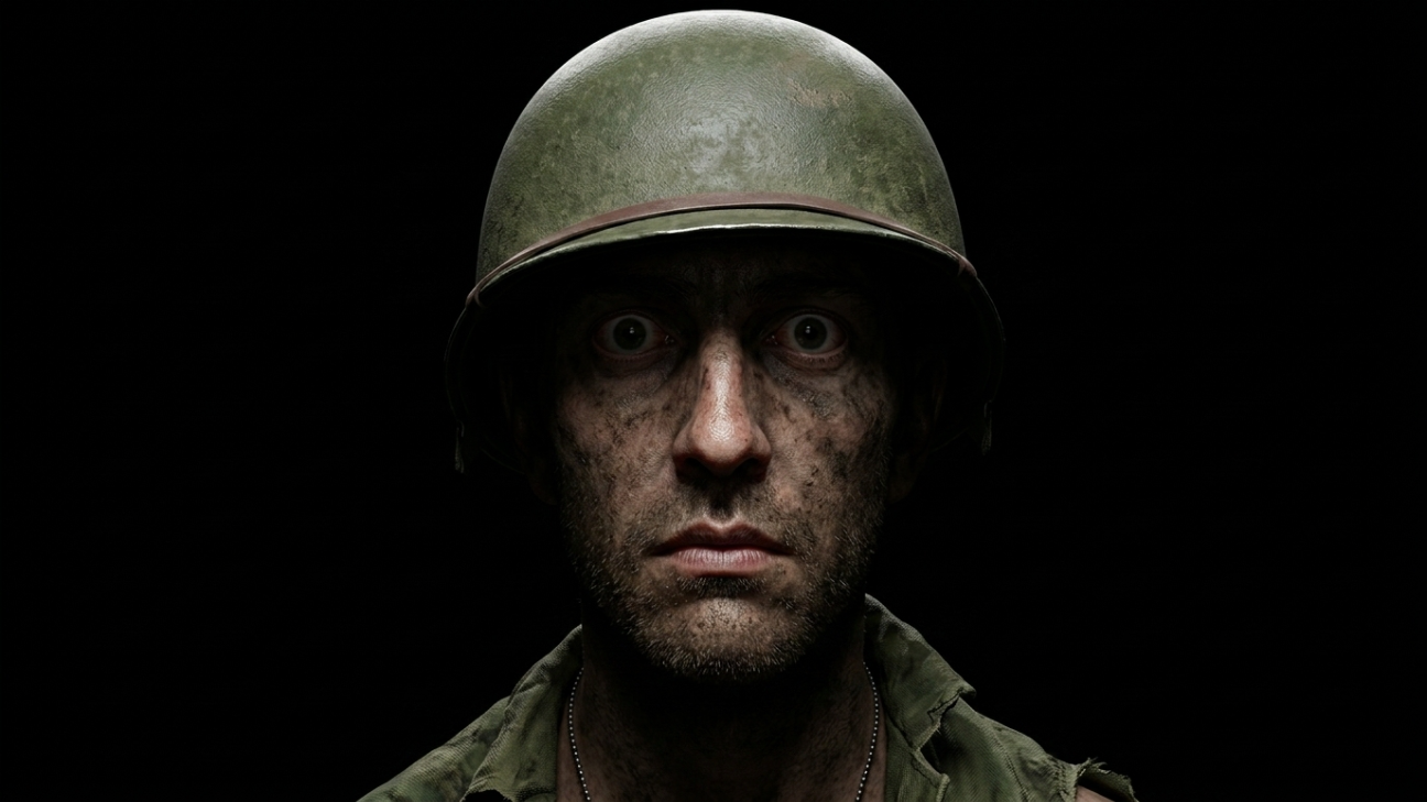 Soldier with mud-camouflaged face, M1 helmet, hollow stare